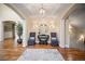 Inviting foyer featuring hardwood floors, elegant lighting, and a glimpse of the staircase and adjoining rooms at 980 E Tufts Ave, Cherry Hills Village, CO 80113