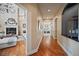 Hallway with hardwood floors leads to a living room with fireplace and upstairs landing at 980 E Tufts Ave, Cherry Hills Village, CO 80113