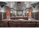 Inviting home theater with tiered seating, a large projection screen, and surround sound system at 980 E Tufts Ave, Cherry Hills Village, CO 80113