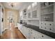 Gourmet kitchen features stone countertops, white cabinetry and hardwood floors at 980 E Tufts Ave, Cherry Hills Village, CO 80113