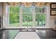 Kitchen window overlooks lush backyard with mature trees, swing set and outdoor seating at 980 E Tufts Ave, Cherry Hills Village, CO 80113