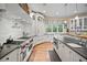 Gourmet kitchen with stainless steel appliances, custom cabinetry, and hardwood floors at 980 E Tufts Ave, Cherry Hills Village, CO 80113