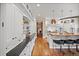 Open kitchen features ample counter space, a center island with bar seating, and hardwood floors at 980 E Tufts Ave, Cherry Hills Village, CO 80113