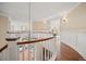 Upstairs landing with white railings and wood floors at 980 E Tufts Ave, Cherry Hills Village, CO 80113