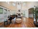 Grand living room with high ceilings, a fireplace, and large windows, creating a bright and inviting space at 980 E Tufts Ave, Cherry Hills Village, CO 80113