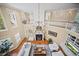 Aerial view of a large living room with a fireplace, chandelier, and white furniture at 980 E Tufts Ave, Cherry Hills Village, CO 80113