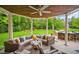 Relaxing outdoor patio with a wicker sectional, ceiling fan, and stone-clad bar, perfect for entertaining at 980 E Tufts Ave, Cherry Hills Village, CO 80113