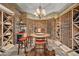 Stunning wine cellar featuring custom wood shelving, stone accents, and a cozy tasting area at 980 E Tufts Ave, Cherry Hills Village, CO 80113