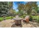 Backyard patio features a seating area with fire pit and well-manicured lawn at 11496 E Wesley Ave, Aurora, CO 80014