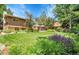 Spacious backyard with lush lawn, mature trees, and an inviting patio area at 11496 E Wesley Ave, Aurora, CO 80014