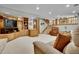 Basement featuring a built-in entertainment unit, desk and staircase at 11496 E Wesley Ave, Aurora, CO 80014