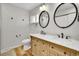 Elegant bathroom featuring a dual sink vanity with marble countertop and dark bronze accents at 11496 E Wesley Ave, Aurora, CO 80014