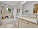 Bright bathroom featuring tile flooring, shower-tub combo, and vanity with mirror at 11496 E Wesley Ave, Aurora, CO 80014