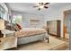 Cozy bedroom with hardwood floors, large windows, a ceiling fan, and a spacious dresser at 11496 E Wesley Ave, Aurora, CO 80014