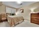 Cozy bedroom with neutral walls, plush bedding, and a comfortable chair at 11496 E Wesley Ave, Aurora, CO 80014