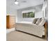 Comfortable bedroom featuring neutral tones, a window, and a classic wood dresser at 11496 E Wesley Ave, Aurora, CO 80014