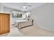 Bright bedroom with a ceiling fan, two windows, and a large dresser for ample storage at 11496 E Wesley Ave, Aurora, CO 80014