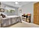 Cozy bedroom with ceiling fan, natural light, and a bookshelf filled with toys and baskets at 11496 E Wesley Ave, Aurora, CO 80014