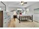 Bright bedroom with a ceiling fan, wood floors, and ample natural light from two windows at 11496 E Wesley Ave, Aurora, CO 80014