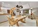 Bright dining area features vaulted ceilings, modern lighting and connects to the living room and kitchen at 11496 E Wesley Ave, Aurora, CO 80014