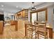 Bright dining area with hardwood floors, modern lighting, and seamlessly connects to the kitchen and living area at 11496 E Wesley Ave, Aurora, CO 80014