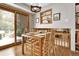 Bright dining room with wood floors, rustic chandelier, and view to backyard at 11496 E Wesley Ave, Aurora, CO 80014