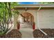 Covered front entrance with brick arch, planters and view through to the interior of the home at 11496 E Wesley Ave, Aurora, CO 80014
