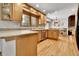 Modern kitchen with hardwood floors, stainless steel appliances and generous counter space at 11496 E Wesley Ave, Aurora, CO 80014