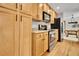 Modern kitchen boasts stainless steel appliances, hardwood floors and lots of storage at 11496 E Wesley Ave, Aurora, CO 80014