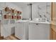 Functional laundry room with washer, dryer, wire shelves, and storage baskets at 11496 E Wesley Ave, Aurora, CO 80014