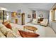 Open living area with neutral walls, carpeting, vaulted ceiling and view into the kitchen and dining area at 11496 E Wesley Ave, Aurora, CO 80014
