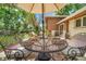 Outdoor patio features dining table, umbrella, and chairs for comfortable entertaining at 11496 E Wesley Ave, Aurora, CO 80014