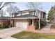 Charming two-story home featuring a brick facade, attached garage, and well-maintained landscaping at 2552 E Alameda Ave # 47, Denver, CO 80209