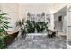 A marble-floored foyer space with decorative wall art and a plant feature at 2552 E Alameda Ave # 47, Denver, CO 80209