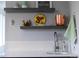 Close up of modern bar featuring floating shelves, white subway tile backsplash, and stainless steel faucet at 3720 Jason St, Denver, CO 80211