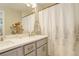 This bathroom features a double vanity, shower, and bathtub combo, with a neutral color palette at 3720 Jason St, Denver, CO 80211