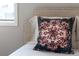 A decorative pillow adds a pop of color and texture to the upholstered headboard at 3720 Jason St, Denver, CO 80211