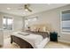 Serene bedroom features a tufted headboard, ceiling fan, neutral color palette, and windows with natural light at 3720 Jason St, Denver, CO 80211