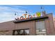 Commercial building featuring a brick facade, a prominent 'Root Down' sign, and a modern industrial aesthetic at 3720 Jason St, Denver, CO 80211