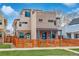 Modern home with brick and stone facade, well-maintained lawn, wood fence, and a charming front porch at 3720 Jason St, Denver, CO 80211