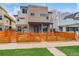 Two-story home with modern design, brick and stone accents, and a well-kept front yard and horizontal wood fence at 3720 Jason St, Denver, CO 80211
