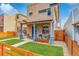 Beautiful home with manicured lawn, covered porch, brick and stone exterior, and wood fence at 3720 Jason St, Denver, CO 80211