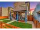 Charming front porch with blue pillars, chairs, and a well-manicured lawn provides a cozy outdoor space at 3720 Jason St, Denver, CO 80211