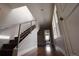 The naturally lit hallway features hard wood floors and a staircase with metal banister at 3720 Jason St, Denver, CO 80211