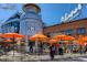 A vibrant outdoor ice cream parlor with a large milk can-shaped structure and orange umbrellas at 3720 Jason St, Denver, CO 80211