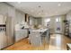 Bright kitchen boasts stainless steel appliances, gray cabinets, a center island with seating, and a door to the outside at 3720 Jason St, Denver, CO 80211