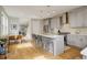 The open-concept kitchen includes a large island with barstool seating, modern light fixtures, and stainless steel appliances at 3720 Jason St, Denver, CO 80211