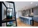 Modern kitchen features sleek gray cabinetry, a large center island with seating, and stainless steel appliances at 3720 Jason St, Denver, CO 80211