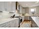Contemporary kitchen features gray cabinets, white countertops, stainless steel appliances, and tile backsplash at 3720 Jason St, Denver, CO 80211