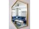 Bright living room reflected in a mirror, featuring a comfortable blue sectional and modern decor at 3720 Jason St, Denver, CO 80211
